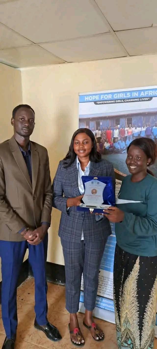 HOFAD receiving a Hope For Girls In Africa recognition award